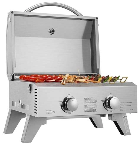 Outdoor van kitchen setup with portable stove and grill